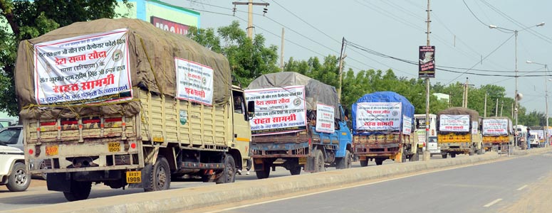 trucks loaded with relief material setting off for Uttarakhand.